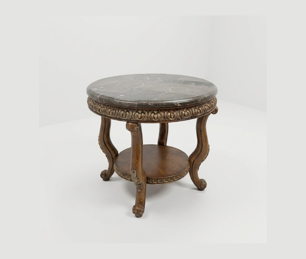 A round marble-topped table on a carved pedestal base