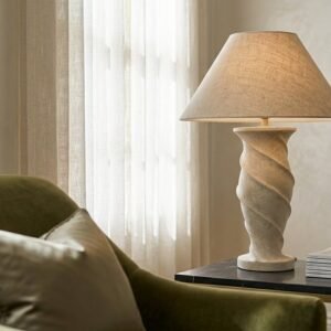 A travertine table lamp with a linen shade
